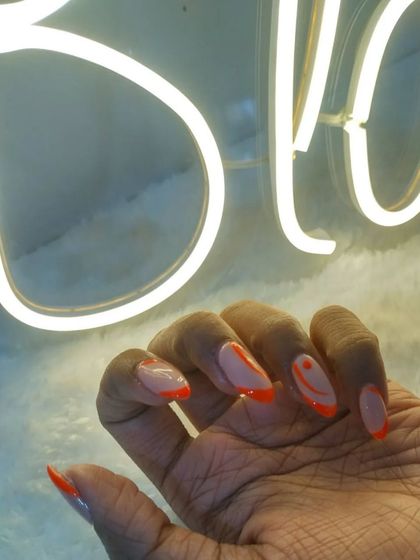 The neon orange abstract nails against our "Bloom" sign.