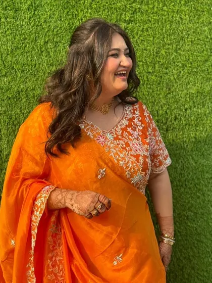 A candid moment showing off the happy bridesmaid glow. The soft makeup and simple hairstyle allow her natural joy and beauty to be the focus.