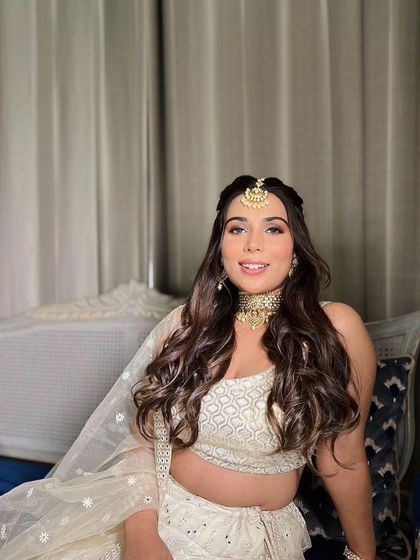 A subtle and glamorous day look for a wedding guest. The soft, romantic curls and glowing makeup create a beautiful and elegant style.