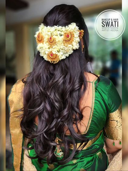 A beautiful hairstyle for our bride Anuja. My artist Swati created soft, open curls and adorned them with a gajra and traditional temple hair accessories.