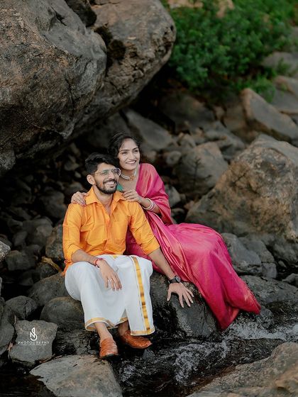 A happy, relaxed pose among the riverside boulders. This shot showcases their easy-going connection.