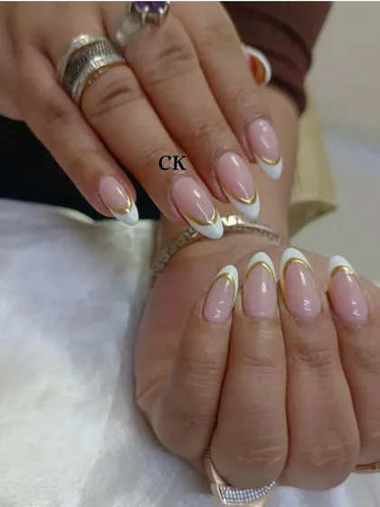 I love giving a modern twist to classic styles. This is an elegant French manicure on almond-shaped extensions, elevated with a sharp, clean line of gold chrome along the tip for a touch of luxury.