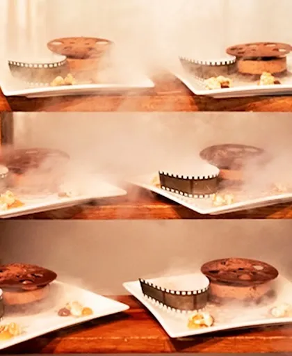 A dessert presented with a dramatic smoky effect using dry ice. This molecular gastronomy technique adds a touch of magic and theatre to our culinary creations, delighting all the senses.