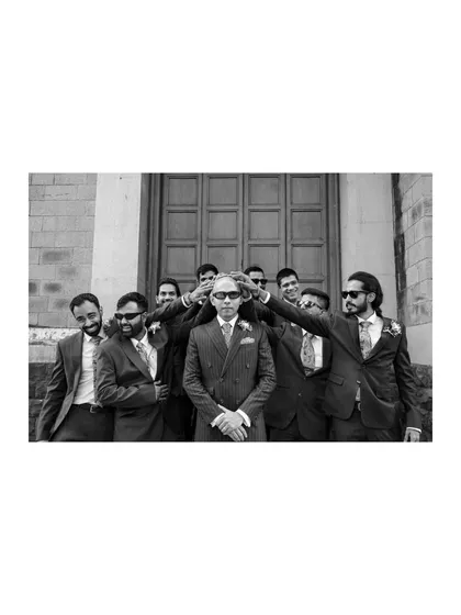 A cool, fun black and white shot of the groom and his groomsmen, perfectly capturing their bond and stylish flair.