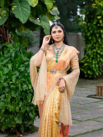 This look from my 'Athiloka Sundari' series features me in a pure Kanchi saree. I paired it with a blouse adorned with intricate embroidery and semi-precious stone embellishments, creating a regal outfit designed to make any bride feel like a princess.