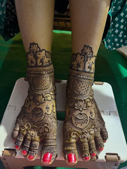 Full coverage bridal feet mehendi. This design is rich with traditional motifs, including lotuses and elephants, matching the bride's hand henna perfectly.