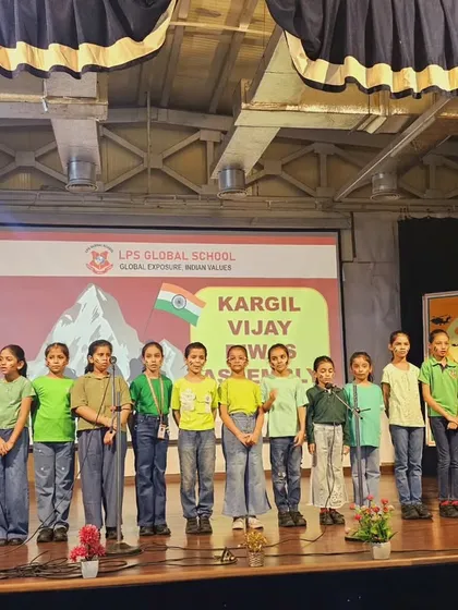 The school choir presents a patriotic song during the Kargil Vijay Diwas assembly, filling the hall with a sense of national pride.