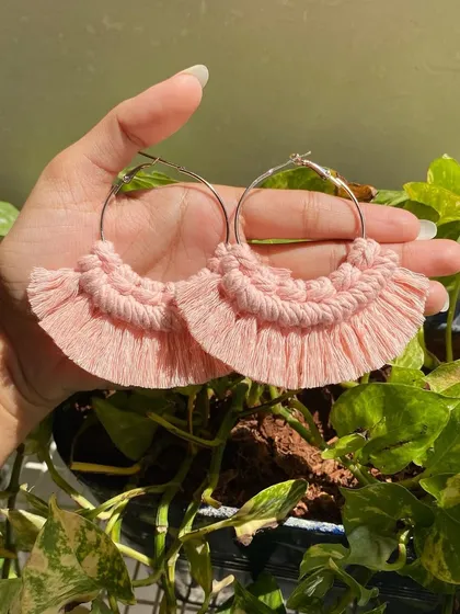Our boho fringe macrame earrings are lightweight and make a beautiful statement. These hoop earrings feature soft, baby pink knotted details and a fringed edge for a touch of bohemian style.