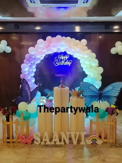 The same butterfly setup seen at night, with the "Happy Birthday" neon sign and balloon arch beautifully illuminated. It shows how my decorations can look amazing day or night.