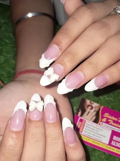 Another view of the delicate 3D bow on this classic white French manicure.