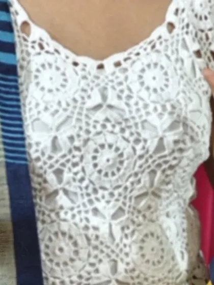 A close-up of the white lace top, showing the detailed pattern of the motifs. I use pure cotton yarn to make it lightweight and breathable, perfect for the Indian climate.