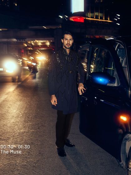 Command attention, exude power, and own the night. This look, captured on a city street at night, is where class meets distinction, and style never has a deadline.