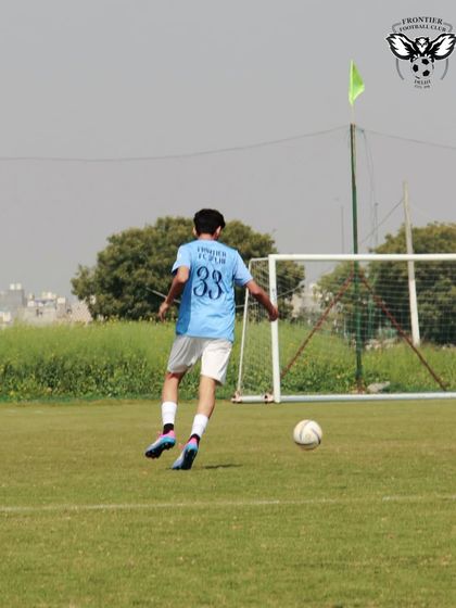 A player about to strike the ball during a practice match. Every action is packed with intent and focus.