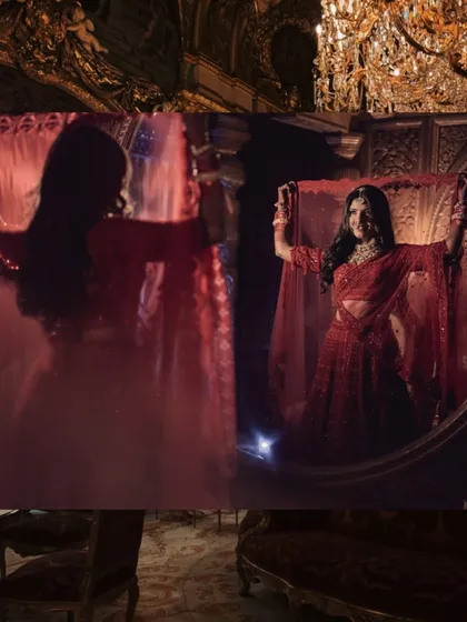 A bride admiring her reflection. This shot uses creative lighting to capture the bride's final look, showcasing her stunning red lehenga and the joy on her face.