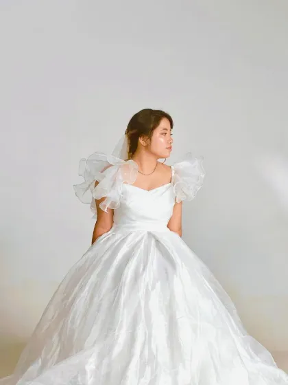 The full, flowing skirt of our white ball gown creates a beautiful shape, perfect for seated or standing portraits during your pre-wedding photoshoot.