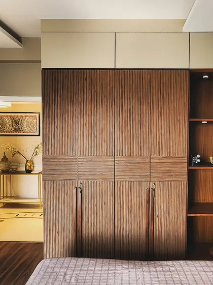 Texture and craftsmanship are at the forefront of this custom wardrobe design. We used fluted wood veneer in two different orientations to create visual interest, complemented by on-site fabricated wooden handles that extend down the length of the doors for a seamless look.