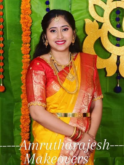 A complete look for this new mom, featuring traditional makeup, gold jewelry, and a perfectly draped saree for her daughter's special day.