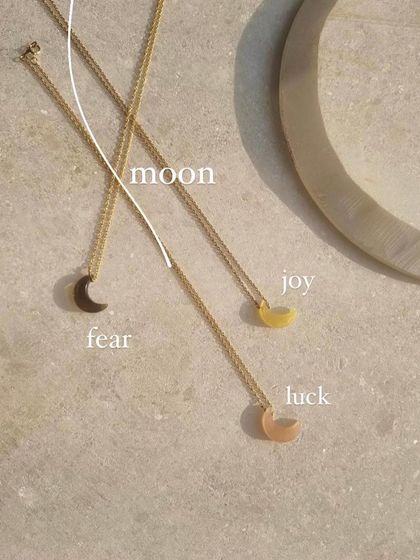 A collection of my Luna pendants. The Smoky Quartz moon is for grounding and dispelling fear, the Yellow Opal moon is for joy, and the Peach Moonstone is for luck.
