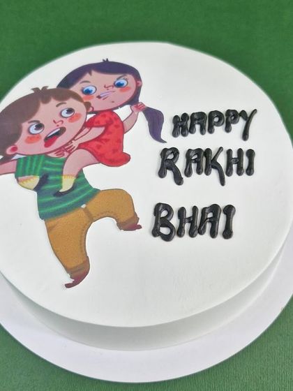 A playful and fun photo cake for Raksha Bandhan, celebrating the fun and fights of siblinghood with the message "Happy Rakhi Bhai".