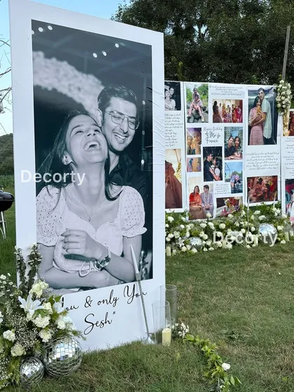 A beautiful black and white portrait of the couple, enlarged and displayed as part of the romantic proposal gallery.