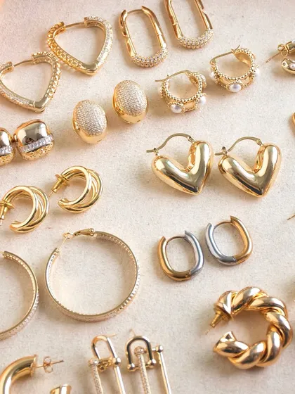 Warning: wearing these hoops may cause instant confidence boosts. This flat lay shows our huge variety of hoop earrings, from studded hearts to braided beauties.