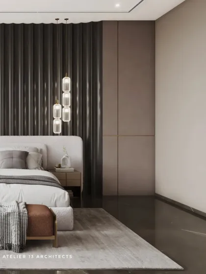 A wider view of the bedroom with the fluted back paneling, showing how the dark wall anchors the space. The design is minimalist yet rich in texture, with pendant lights adding a soft glow.