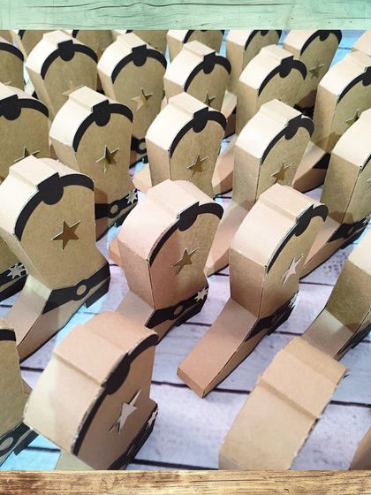 A whole posse of cowboy boot gift boxes, ready for a Wild West party.