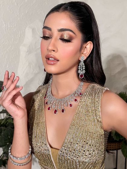 A glamorous pose showing off a golden cocktail look. The metallic eyeshadow and glowing skin are perfect for an evening celebration.