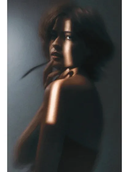 A soft, blurry portrait created during my Sigma lens review. I often play with focus and light to create emotion. This image, with its sliver of light on the model's face, is a perfect example of that experimental process.