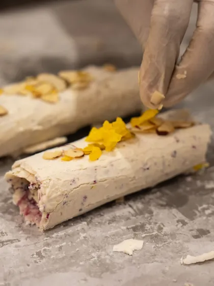 A chef carefully adds the final garnishes to our Mishti Malai rolls. This close-up shows the attention to detail and craftsmanship that goes into every dessert we serve.