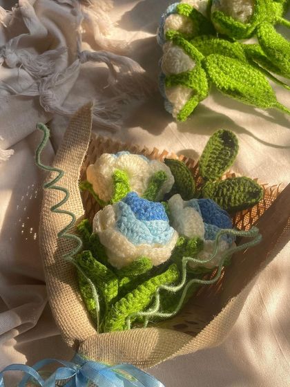 The blue and white bouquet, unwrapped and lying on a piece of burlap, ready to be arranged.