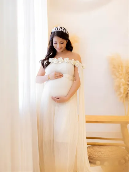 A full-length view of this beautiful off-shoulder gown with floral details, showing how it drapes and flows.