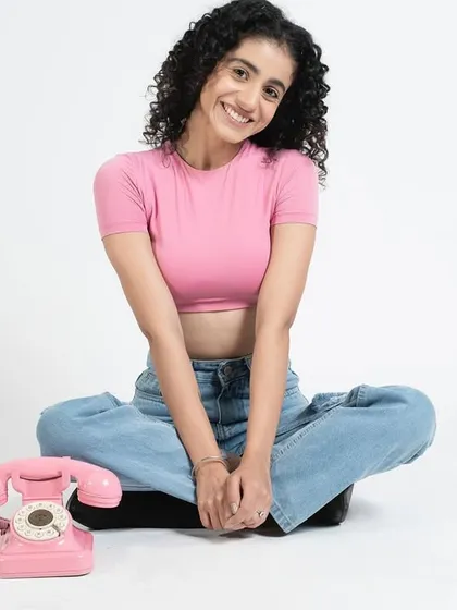 Another shot from the monochrome pink shoot. The model's happy expression and the clean makeup create a light and playful vibe.