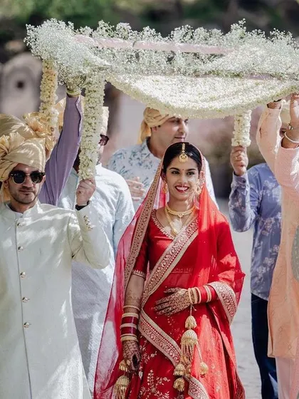 The bridal entry is a pivotal moment. I designed this delicate 'phoolon ki chadar' using a web of baby's breath, creating a light, ethereal canopy that looked beautiful against the bride's traditional red lehenga.