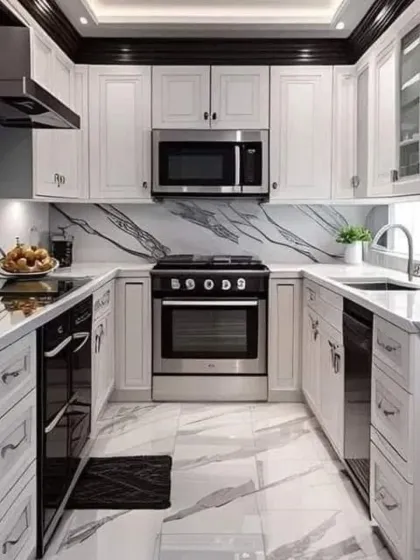A compact yet powerful U-shaped kitchen design featuring classic white shaker-style cabinets contrasted with black hardware and appliances. We used a dramatic black and white veined quartz for both the countertop and floor, creating a cohesive and high-end look.