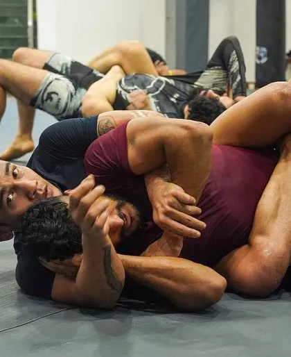 A tangle of limbs during a No-Gi roll shows the complexity of high-level grappling. Our advanced classes dive deep into these intricate positions.