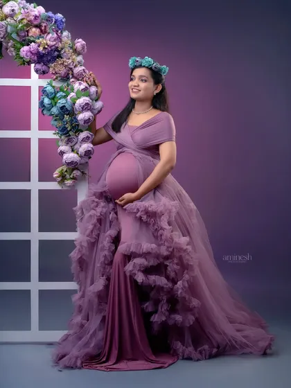 Here, I've incorporated a window prop and floral arch to add architectural and natural elements to the portrait. It creates a beautiful frame for the mother-to-be in her stunning ruffled gown.