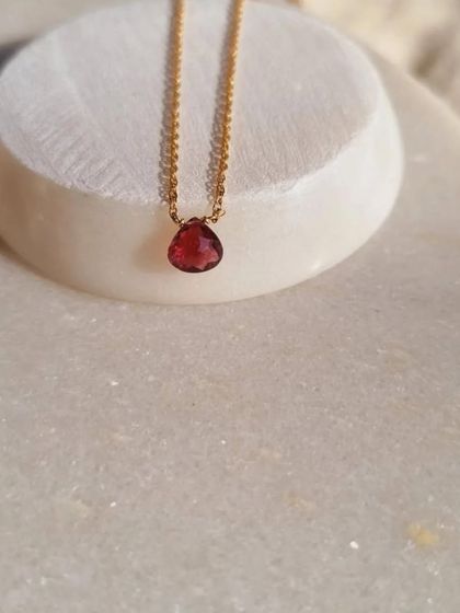 A close-up of my Pink Tourmaline heart-shaped drop pendant. I cut this stone to represent love and compassion, making it a powerful talisman for emotional healing and opening the heart.