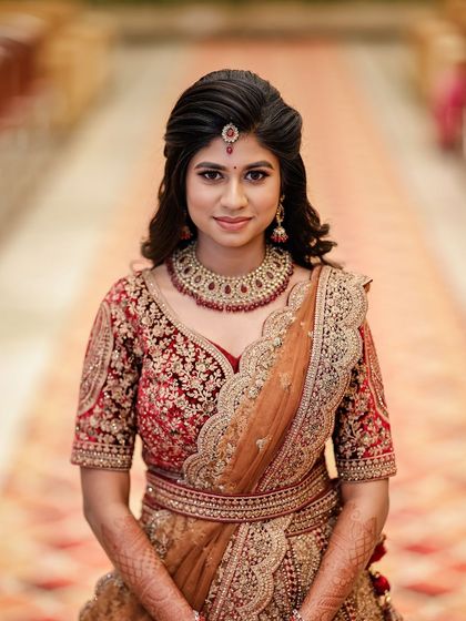 A classic portrait of the bride on her reception day. The makeup is elegant and polished, with a focus on creating a flawless canvas for her beautiful features.