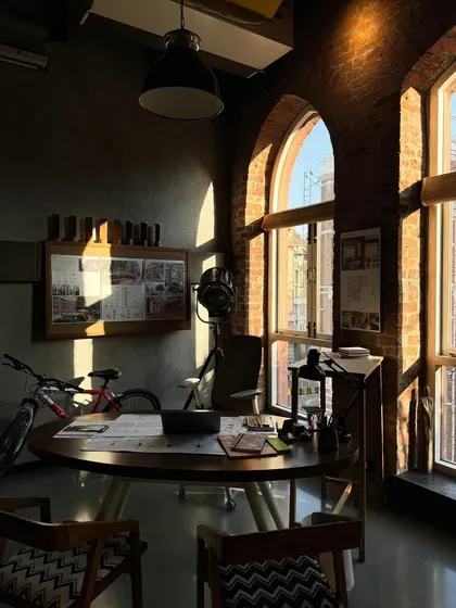 The 'Thinker's Corner' at golden hour. The light catches the mood board and the blackboard where we sketch out ideas, showcasing the creative heart of our studio.
