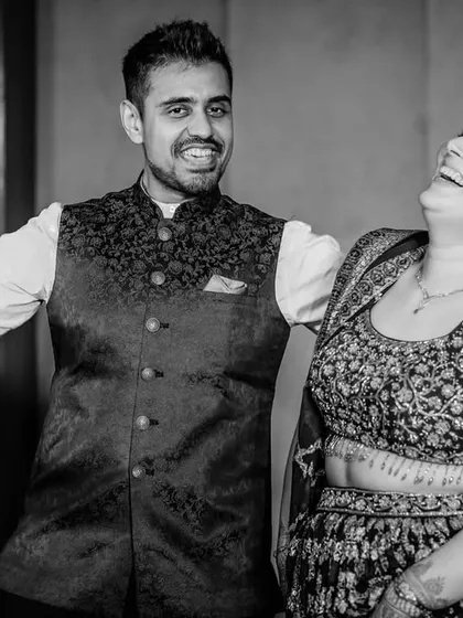 Pure happiness in black and white. This candid shot captures the couple sharing a huge laugh, showcasing their easygoing and fun-loving connection.