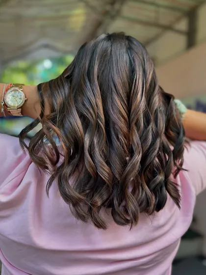 Brunette and thriving. This is a classic, chic look with a fresh cut and subtle brown highlights to add movement and shine, all done without bleach.