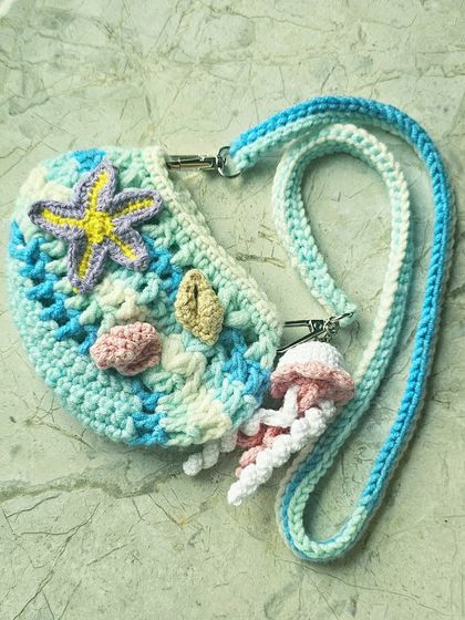 A different angle of the mini Ocean Bag, showing the adjustable crossbody strap and the cute little seashell and starfish details. It's a perfect handmade gift for a child's birthday.