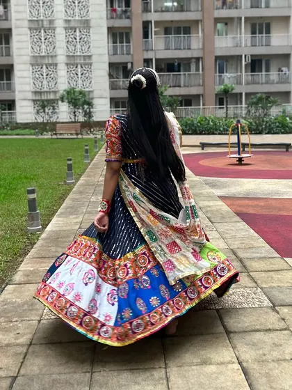 A view from the back, showing how the dupatta is draped and how the lehenga flows as you walk. This outfit looks stunning from every angle.