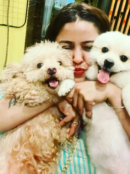 For me, it's not just a business, it's a life full of love. I get to cuddle these adorable babies all day. This is me with two of my happy guests, who are all smiles after a fun day of play.