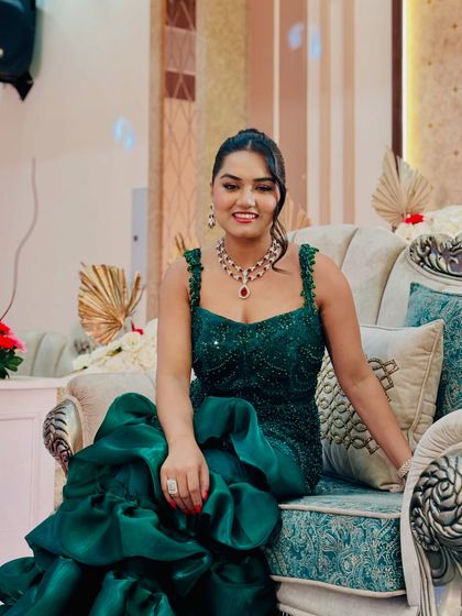 A full-look shot of my green evening gown. The detailed craftsmanship and rich color make it one of my favorites for hosting a formal wedding function.