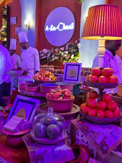 A vibrant and bustling live chaat counter from our 'A-la-Chaat' offering. This setup brings the lively flavors of Indian street food to any event with a gourmet twist.