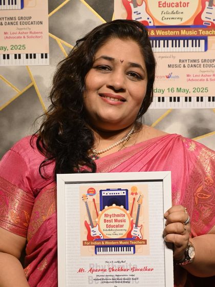Ms. Aparna Shekhar Biwalkar with her Rhythmite Best Music Educator Award, recognizing her contribution to teaching classical singing.