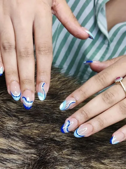 Another view of the blue and white abstract wave manicure.