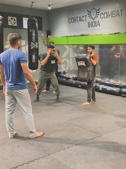 I am always supervising my students, ensuring they are using proper technique and training safely. Here, I watch over a pad work drill.
